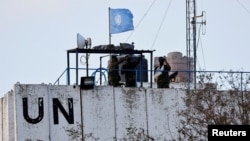 FILE PHOTO: United Nations peacekeepers (UNIFIL) look at the Lebanese-Israeli border